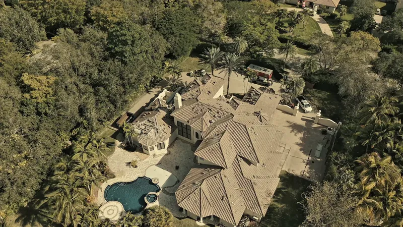 Finished tile roof on a Pinecrest home surrounded by mature trees, seen from above